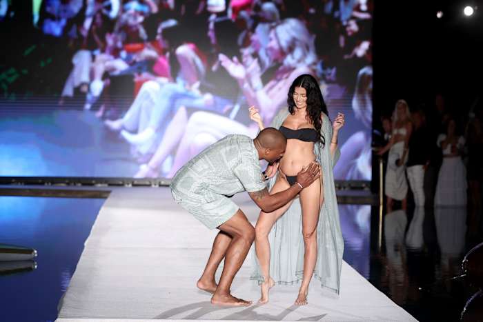 Larry English and Nicole Williams English walks the runway for Sports Illustrated Swimsuit Runway Show During Paraiso Miami Beach on July 16, 2022 in Miami Beach, Florida.